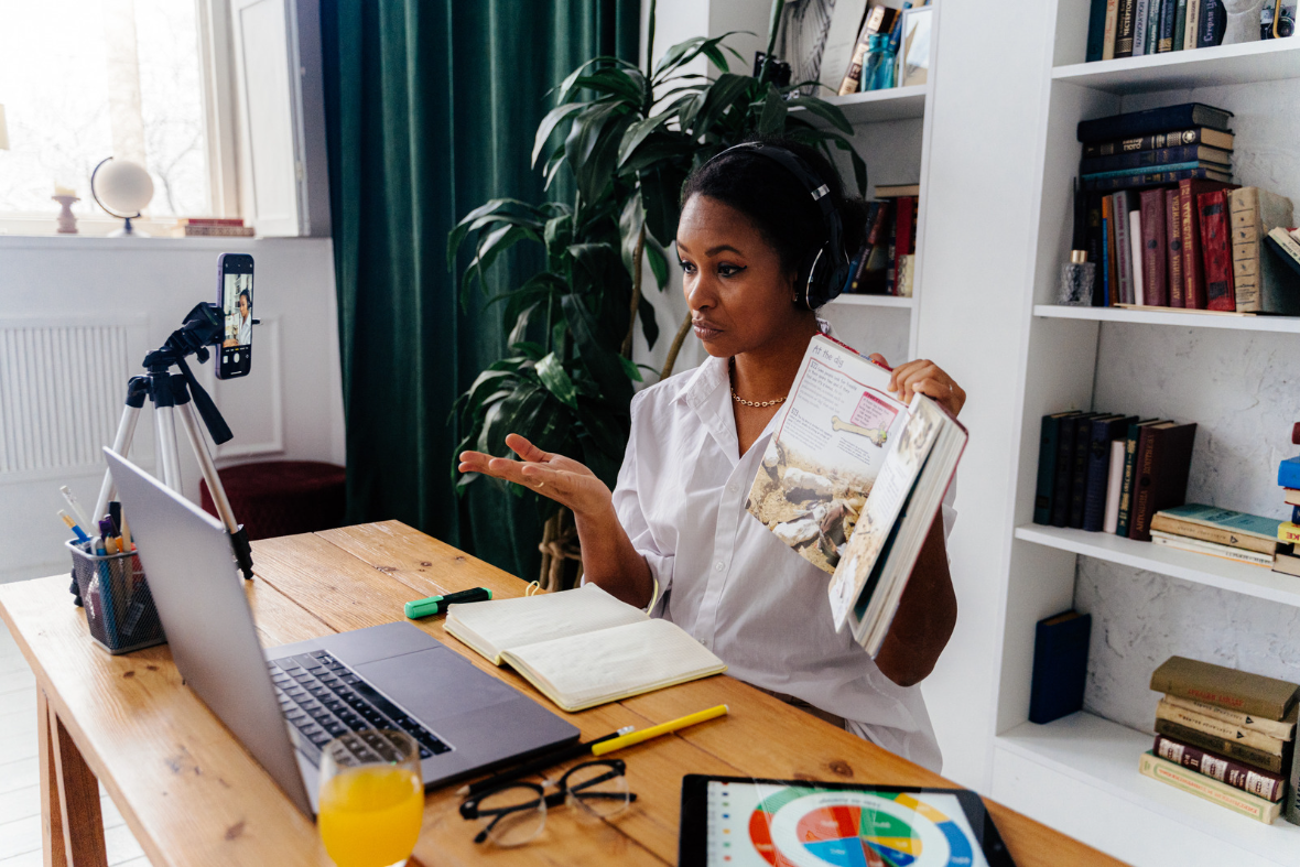 An online teacher teaching on Lrnkey platform, sitting in front of the computer and sharing knowledge with the student